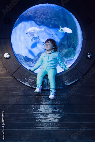 Adorable little girl at the oceanarium photo