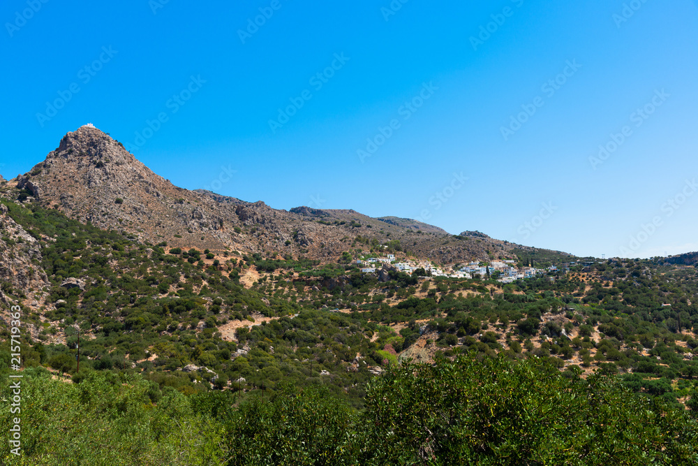 Village on Lasithi Makrigialos mountains. Wonderland tour, steep slopes, rocky peaks for hiking adventure recreation sports in Crete, Greece.