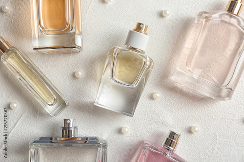 Beautiful composition with bottles of perfume on white background, flat lay