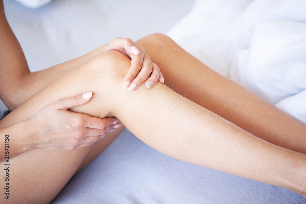 Hand Pain. In Stress. Woman Runner Suffering From Knee Pain Sit On The Bed
