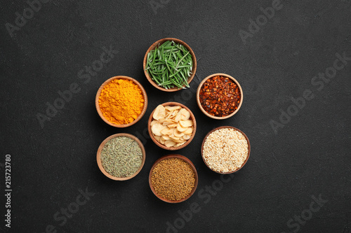 Fototapeta Naklejka Na Ścianę i Meble -  Flat lay composition with different aromatic spices on dark background