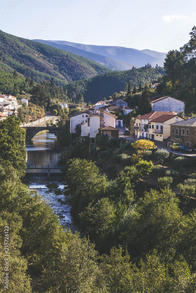 View of the valley in the mountains of Portugal with the river and the city on a sunny day