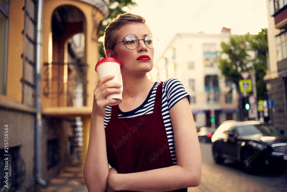 woman in glasses with coffee on the sunset street