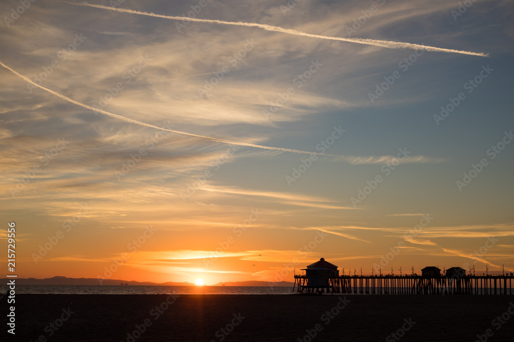 peaceful coastal sunset with a silhouette of the Huntington Beach Pier