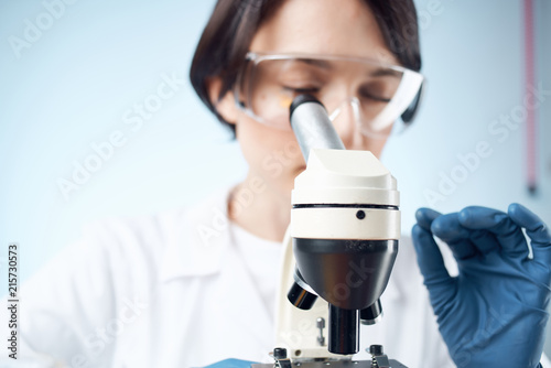 laboratory assistant with a microscope