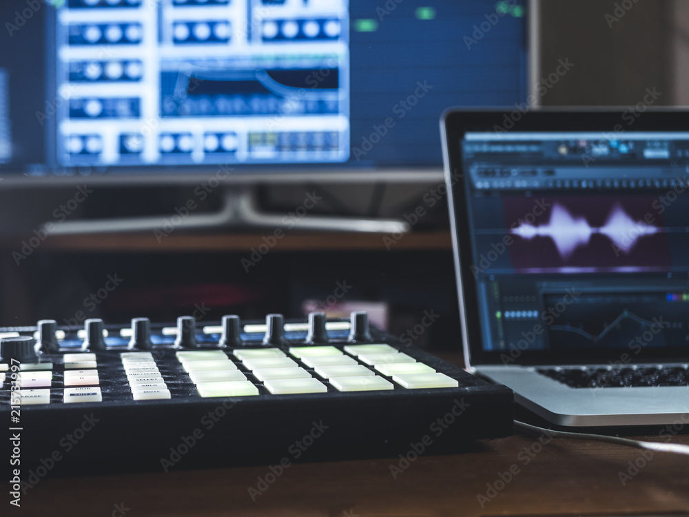 close up music machine with pads on the table sound work place with laptop and external monitor close up music machine with pads on the table sound work place with laptop and external monitor