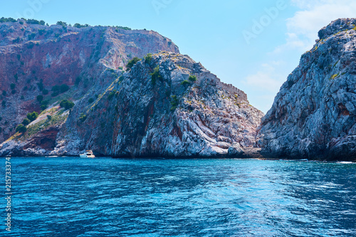 A boat and rocks on a sea coast of Alanya  Turkey.  