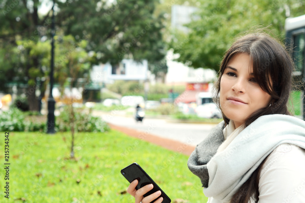 Young woman sending message with smartphone. Young woman sending message with smartphone.