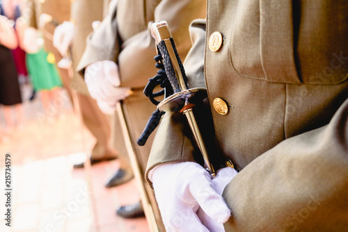Army soldiers with gloves holding their sabers waiting to be checked by the superior