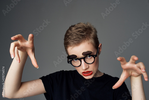 woman in glasses on gray background