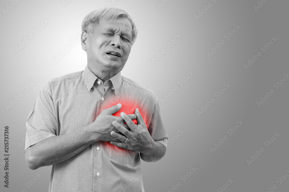 Older asian man clutching and having chest pain cause from heart attack