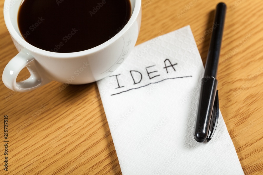 Cup of Coffee with Word Idea on Napkin Cup of Coffee with Word Idea on Napkin