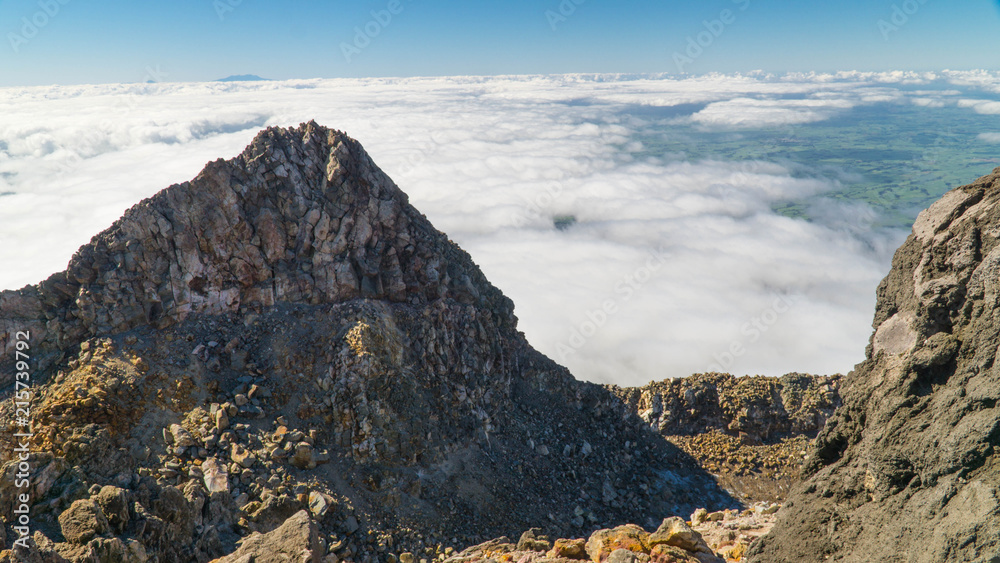 Obraz premium Above clouds after hard hike to the top of Mt. Taranaki, New Zealand