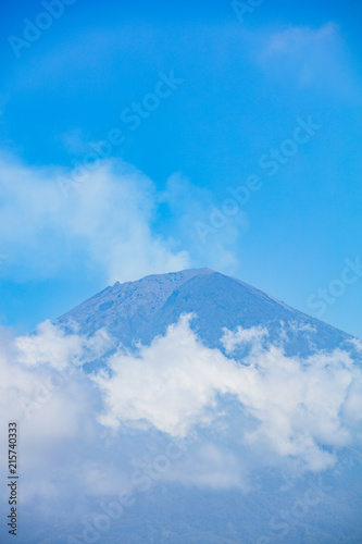 Mount Agung with smoke from the crater and clouds beneath, july 2018, couple of weeks after last eruption with lava.