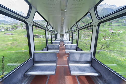Interior of a passenger train with empty seats