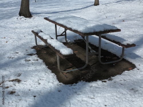 Park in Winter - Benches and tables stacked with park closed for the season with snow cover in winter.
