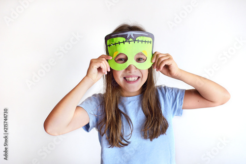 The girl plays the fool in a mask of the monster for Halloween