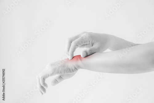 Woman scratching her wrist.