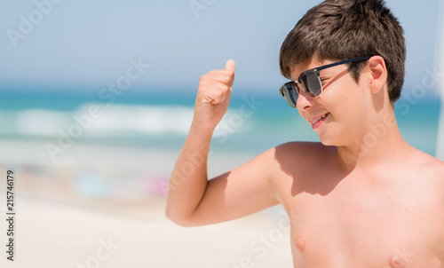 Young child on holidays by the beach screaming proud and celebrating victory and success very excited, cheering emotion