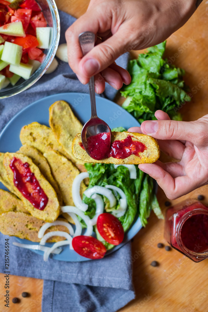 Crispy corn breads slices. Spicy and tasty on plate with green salad leaves, onion rings and tomatoes. Vegan lunch or vegetarian dinner. Healthy food concept. Crispy corn breads slices. Spicy and tasty on plate with green salad leaves, onion rings and tomatoes. Vegan lunch or vegetarian dinner. Healthy food concept.