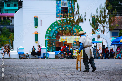 Señor camina con bastón frente al templo principal  de San Juan Chamula Chiapas. photo