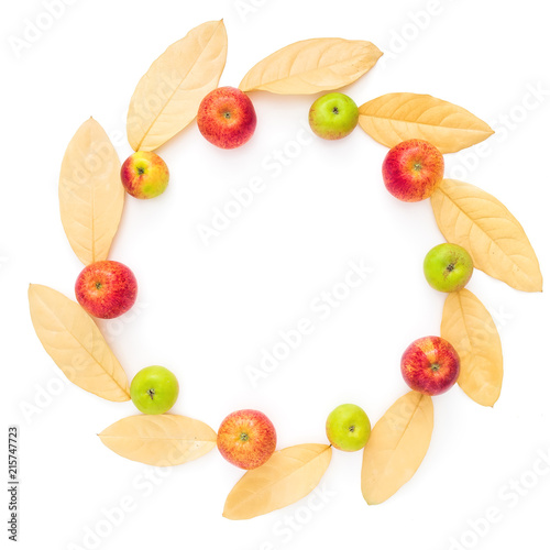 Autumn round frame of autumn dried leaves and apple fruits on white background. Flat lay, top view, copy space