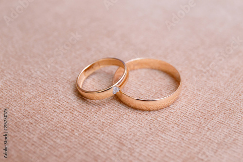 Two beautiful wedding rings on cloth background, close-up