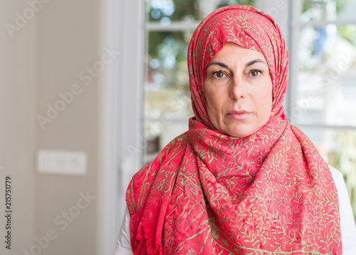 Middle aged muslim woman wearing hijab with a confident expression on smart face thinking serious