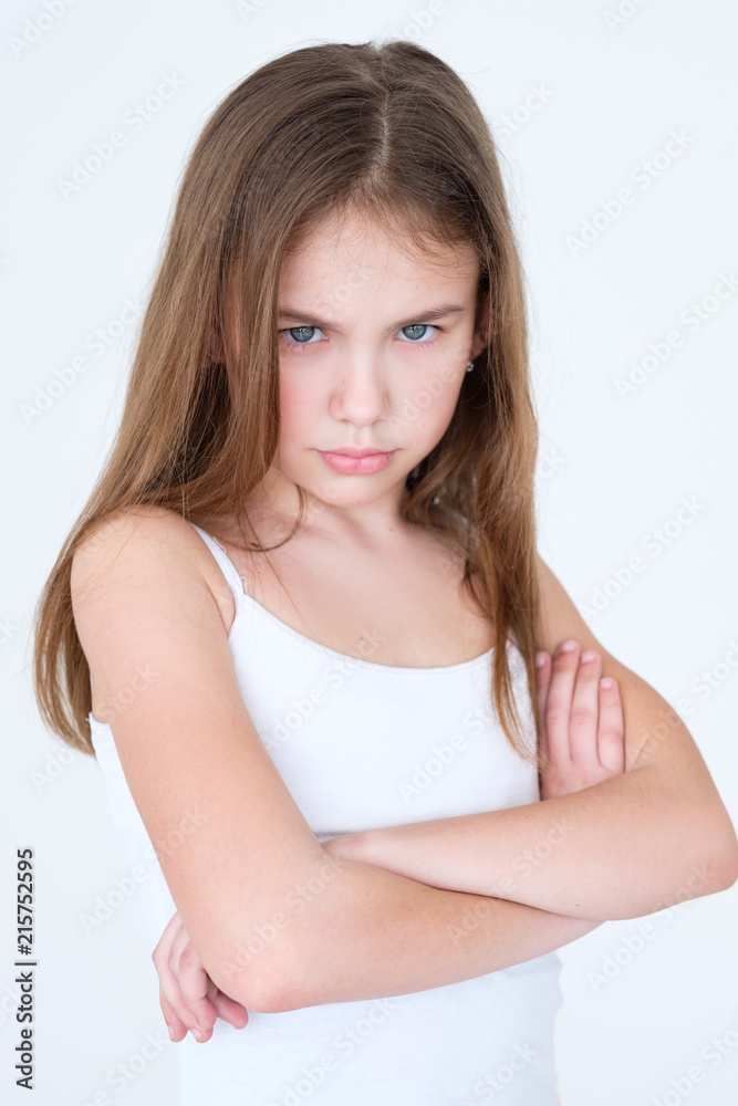 emotion face. sad hurt offended child with arms crossed. little girl portrait on white background. mood feelings personality and facial expression concept emotion face. sad hurt offended child with arms crossed. little girl portrait on white background. mood feelings personality and facial expression concept