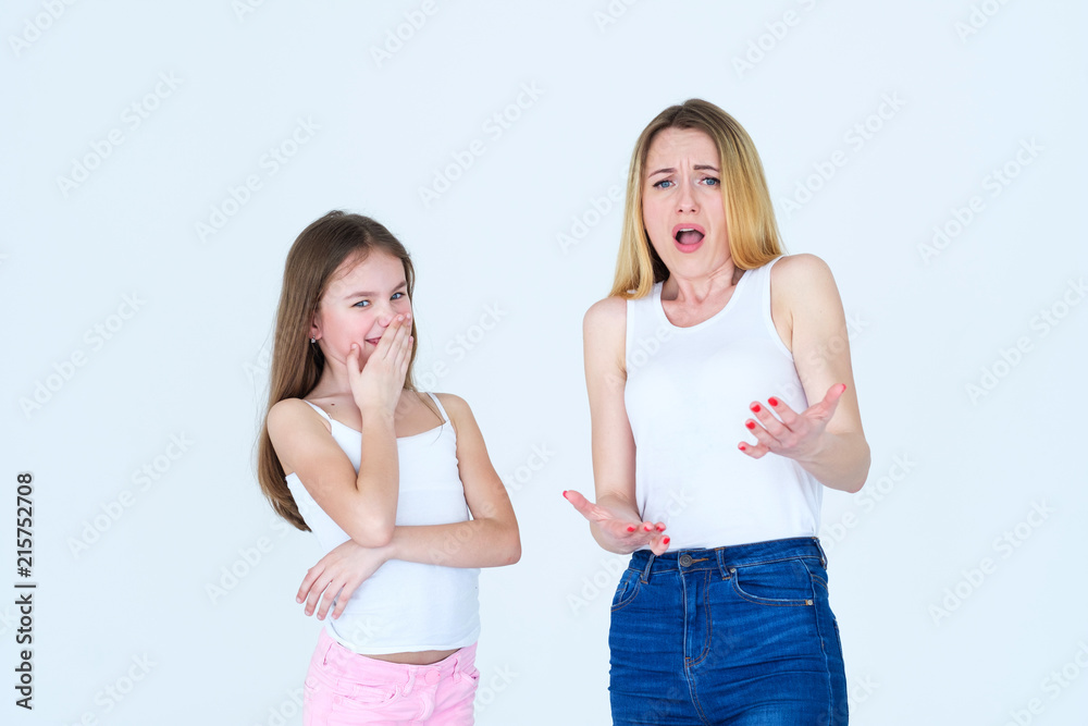 opposite reaction of mom and child daughter. generation difference. mother is appalled and confused, kid is laughing. opposite reaction of mom and child daughter. generation difference. mother is appalled and confused, kid is laughing.