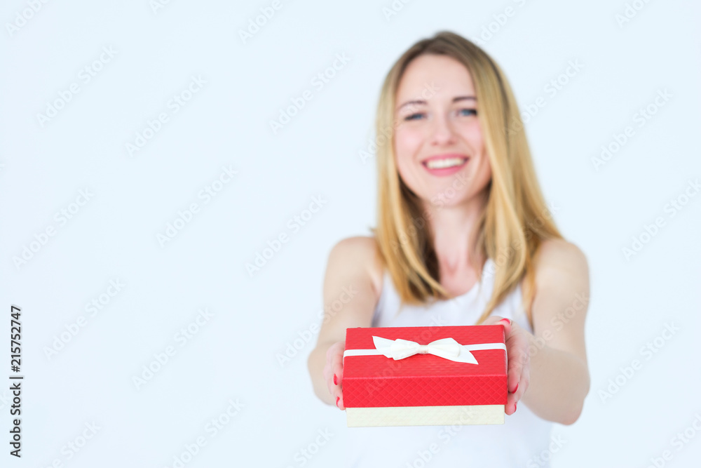woman holding a party present in a red gift box. celebration and congratulations concept.