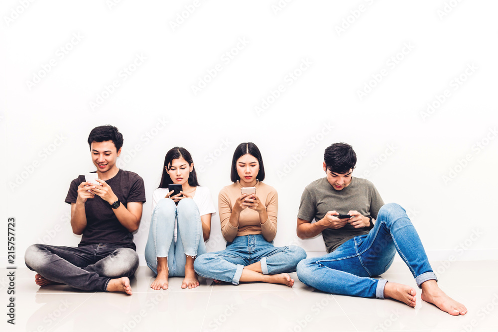 Group of friend sitting relax use technology together of smartphone checking social apps against copy space background.Communication concept Group of friend sitting relax use technology together of smartphone checking social apps against copy space background.Communication concept