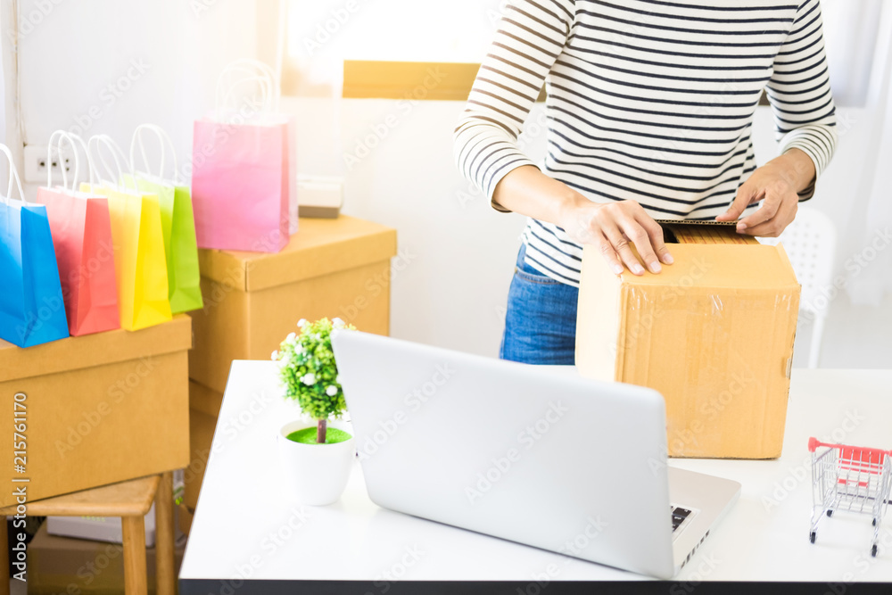 e-commerce delivery concept and online selling start up small business owner packing in the card box at workplace. freelance woman seller prepare product for packaging process at shop e-commerce delivery concept and online selling start up small business owner packing in the card box at workplace. freelance woman seller prepare product for packaging process at shop