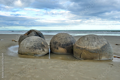 Stone balls on a sandy beach in New Zealand