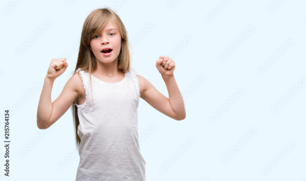 Young blonde toddler screaming proud and celebrating victory and success very excited, cheering emotion Young blonde toddler screaming proud and celebrating victory and success very excited, cheering emotion