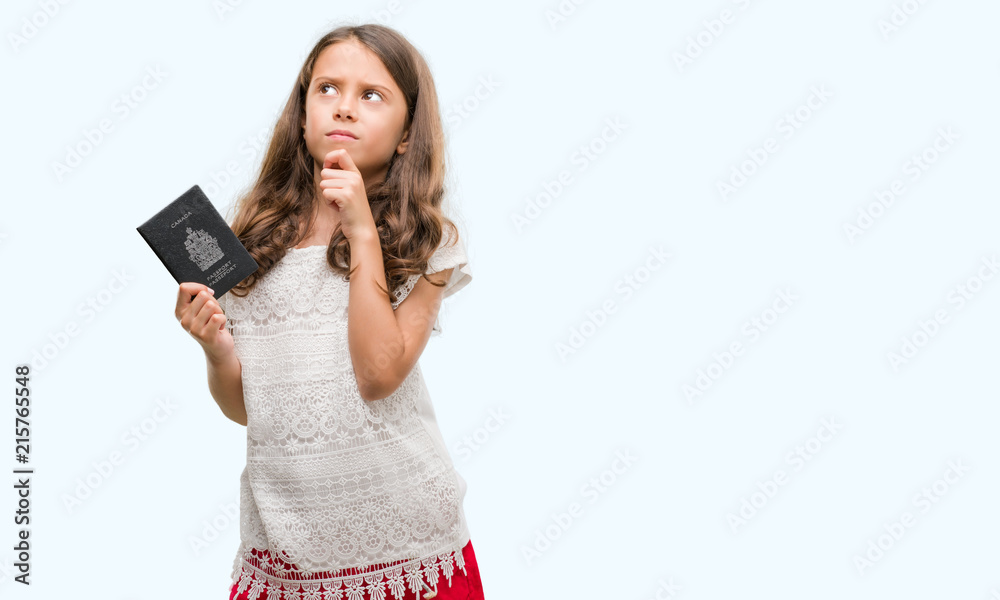 Brunette hispanic girl holding passport of Canada serious face thinking about question, very confused idea Brunette hispanic girl holding passport of Canada serious face thinking about question, very confused idea