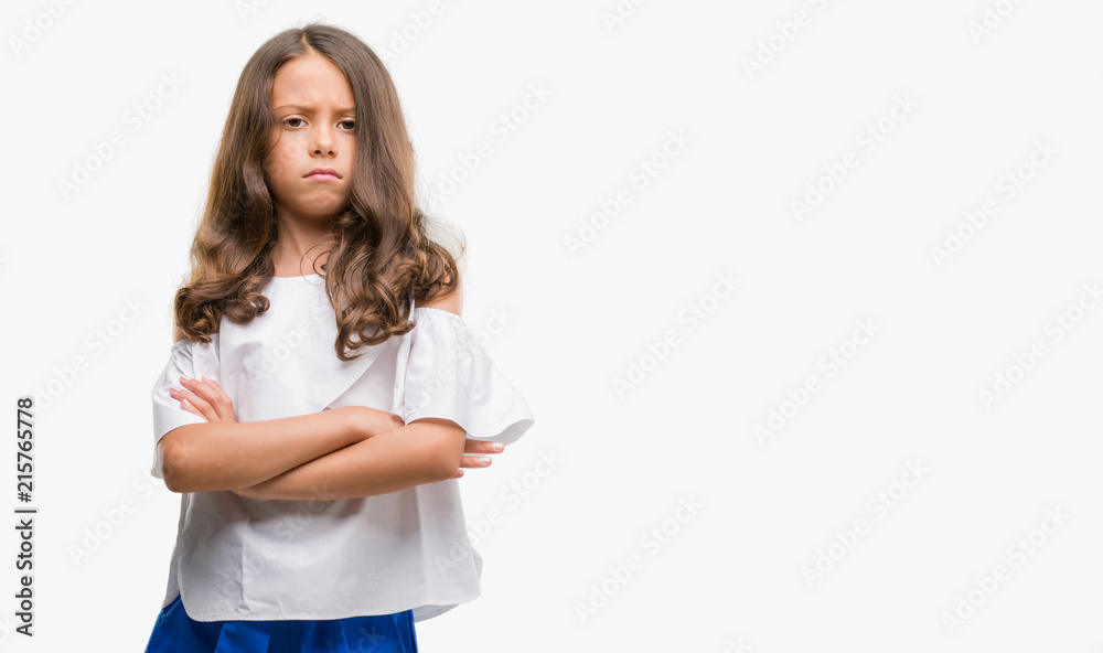 Brunette hispanic girl skeptic and nervous, disapproving expression on face with crossed arms. Negative person. Brunette hispanic girl skeptic and nervous, disapproving expression on face with crossed arms. Negative person.