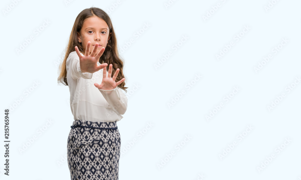 Brunette hispanic girl afraid and terrified with fear expression stop gesture with hands, shouting in shock. Panic concept. Brunette hispanic girl afraid and terrified with fear expression stop gesture with hands, shouting in shock. Panic concept.