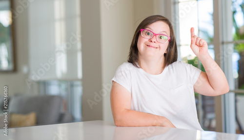 Down syndrome woman at home surprised with an idea or question pointing finger with happy face, number one Free Download Down syndrome woman at home surprised with an idea or question pointing finger with happy face, number one - GFXLoad