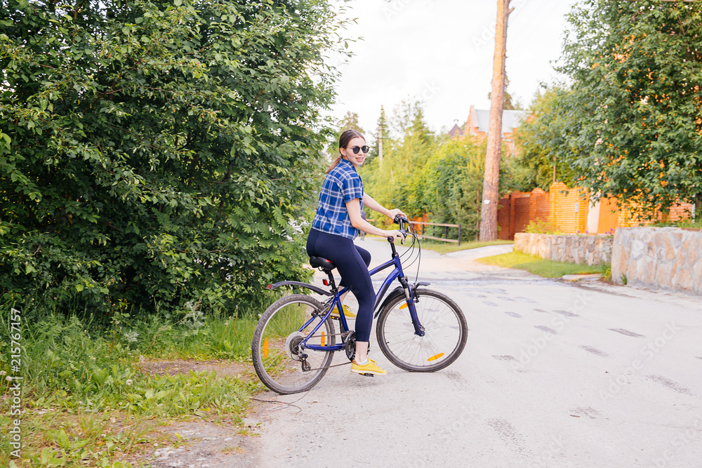 Fototapeta premium Young woman riding a bike