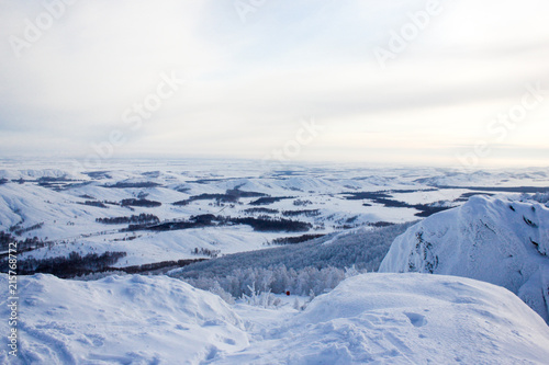 Winter landscape  snowy Ural mountains in cloudy day  trees in frost