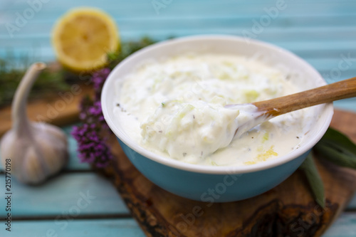 Traditional Greek tzatziki sauce and ingredients for the recipe.
