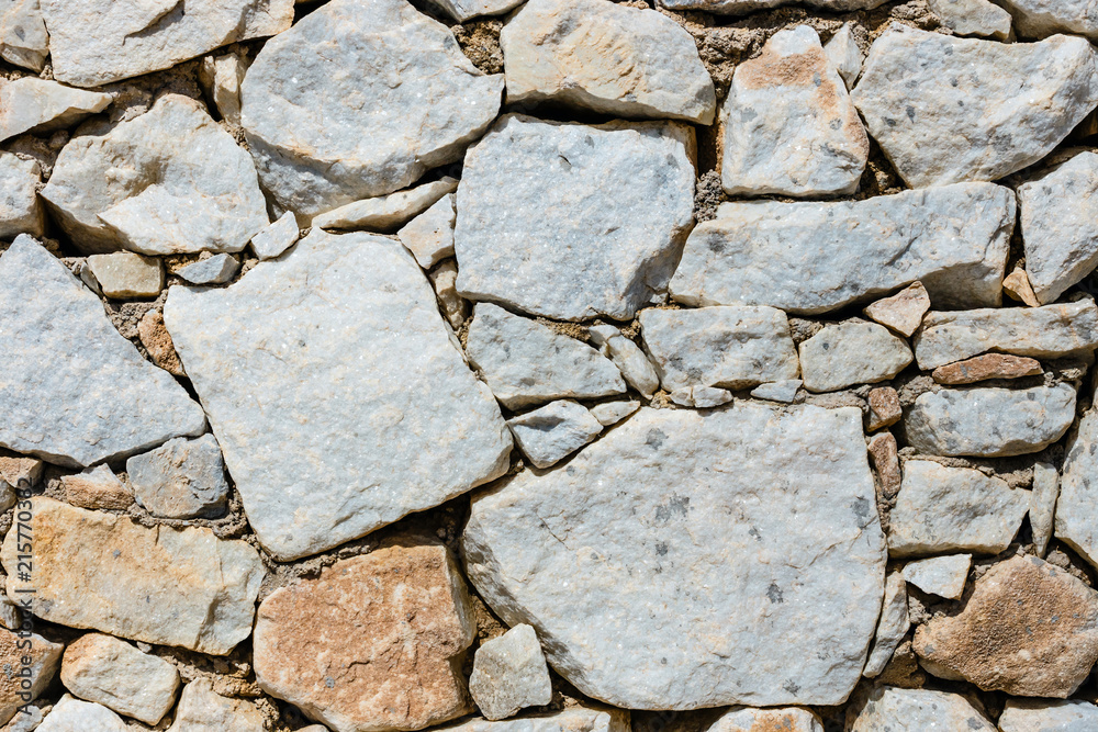 Fototapeta premium Texture of a stone wall as background