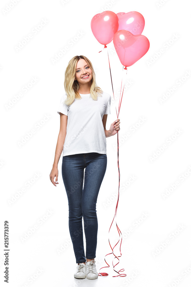 beautiful girl in casual clothes holding bundle of heart shaped balloons isolated on white beautiful girl in casual clothes holding bundle of heart shaped balloons isolated on white