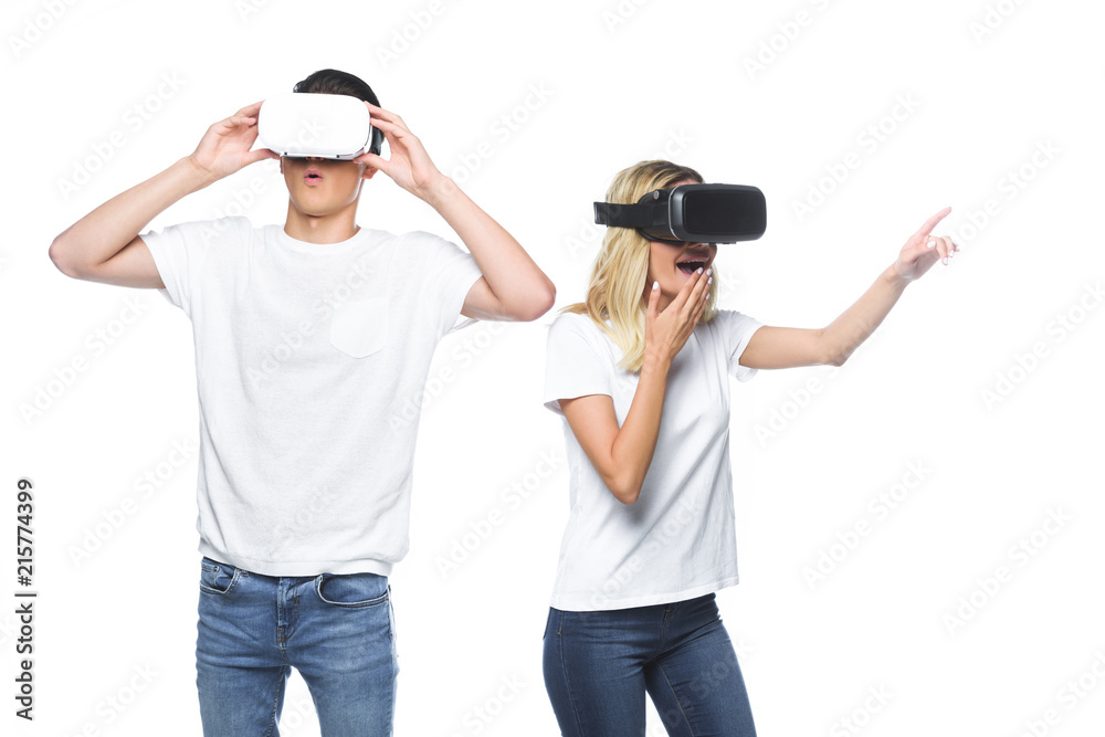 surprised couple using virtual reality headsets isolated on white surprised couple using virtual reality headsets isolated on white