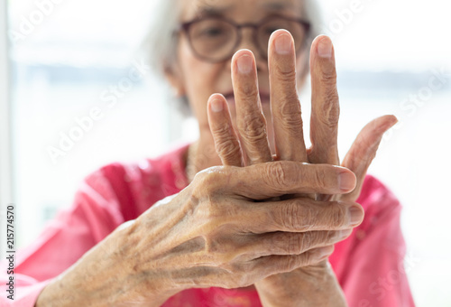 Elderly woman suffering from pain in hand,arthritis,beriberi photo