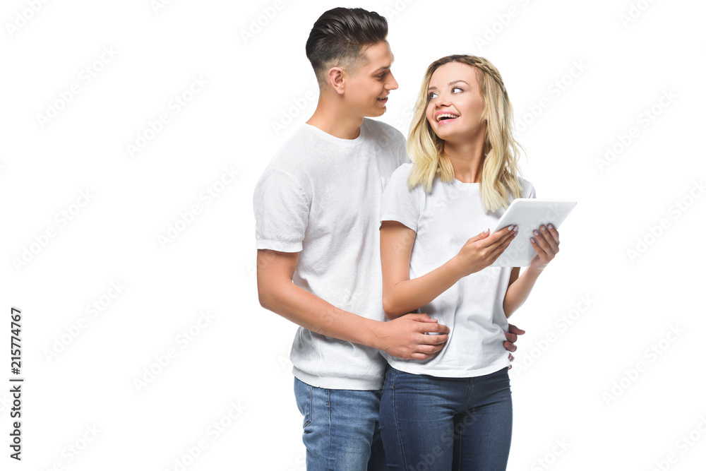happy couple hugging and using tablet together isolated on white happy couple hugging and using tablet together isolated on white