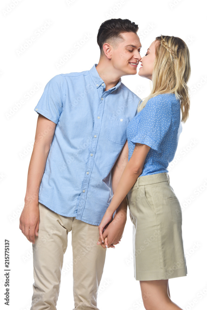 smiling couple in blue shirts kissing isolated on white smiling couple in blue shirts kissing isolated on white