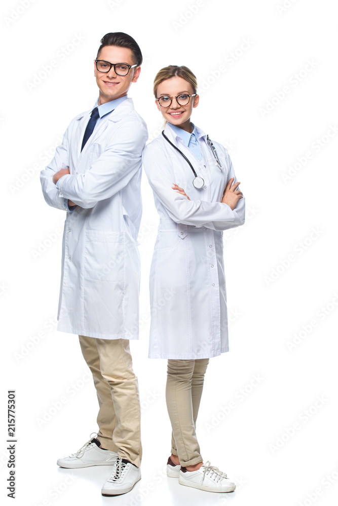 doctors standing with crossed arms and looking at camera isolated on white doctors standing with crossed arms and looking at camera isolated on white