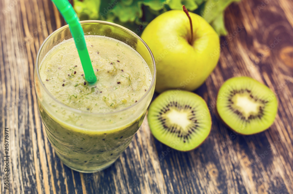 Healthy green smoothie with kiwi, apple on rustic wood background, top view Healthy green smoothie with kiwi, apple on rustic wood background, top view